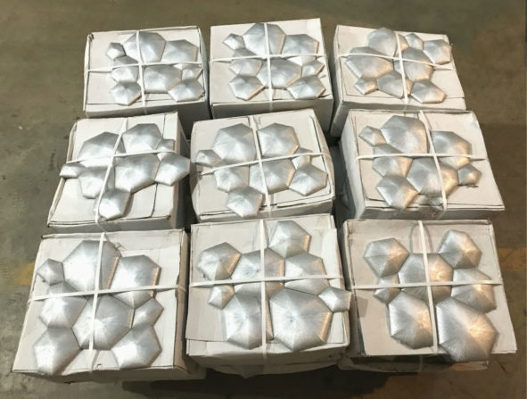 Photo of a pallet of three-dimensional silver sunburst tile